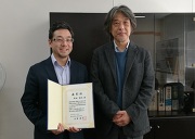 （左側：関崎助教、右側：青木三郎人文社会系長）